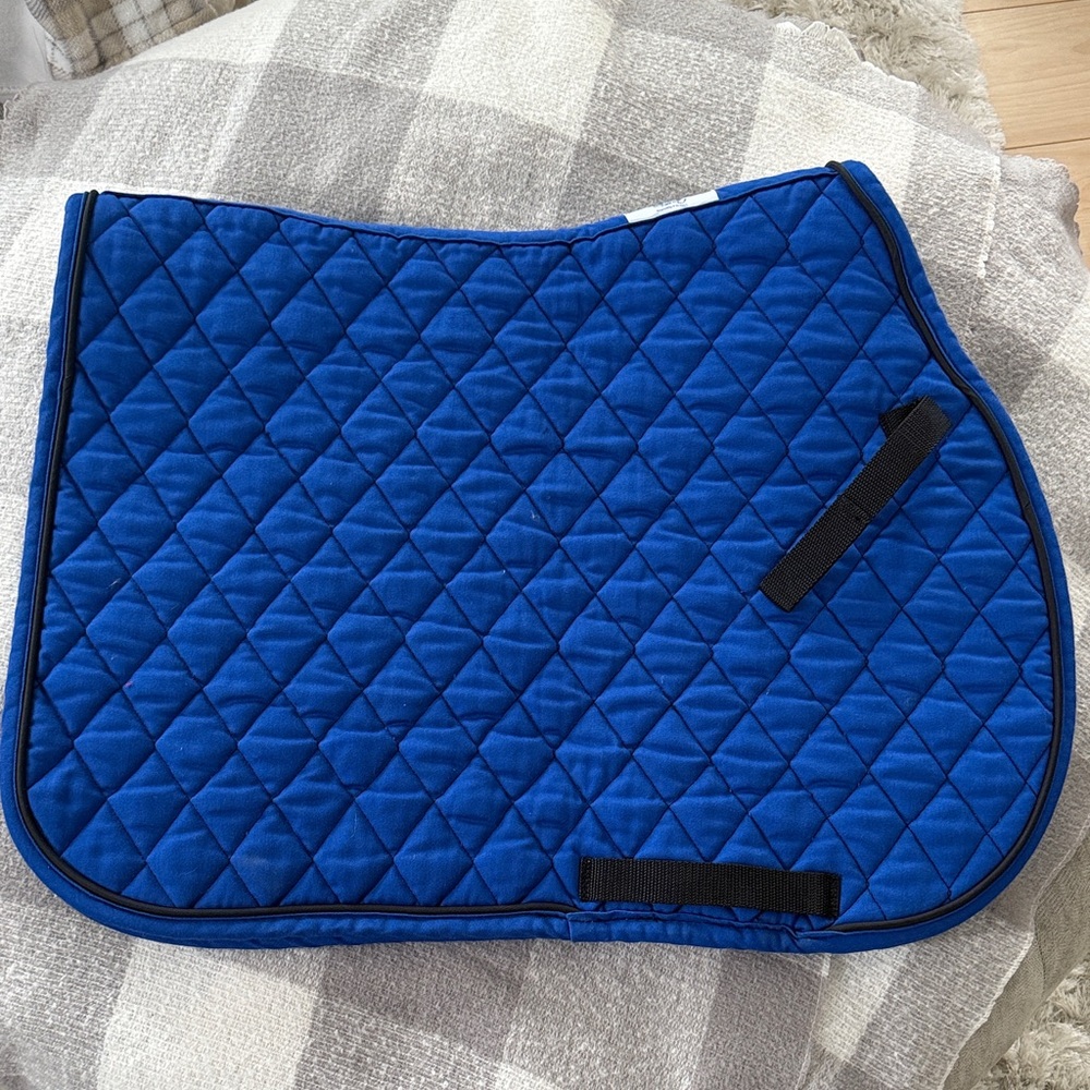 Royal blue saddle pad with black piping and trim